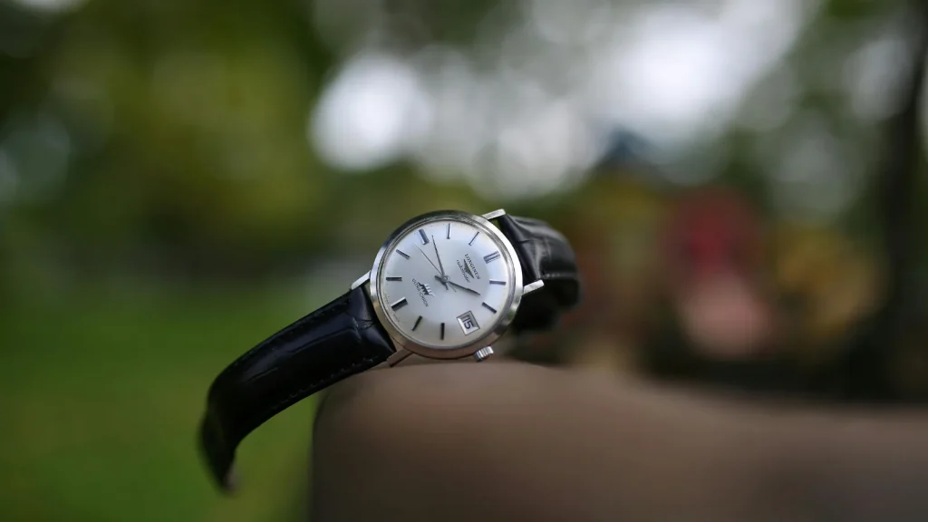 Longines Ultra-Chron watch photographed outdoors with a blurred background